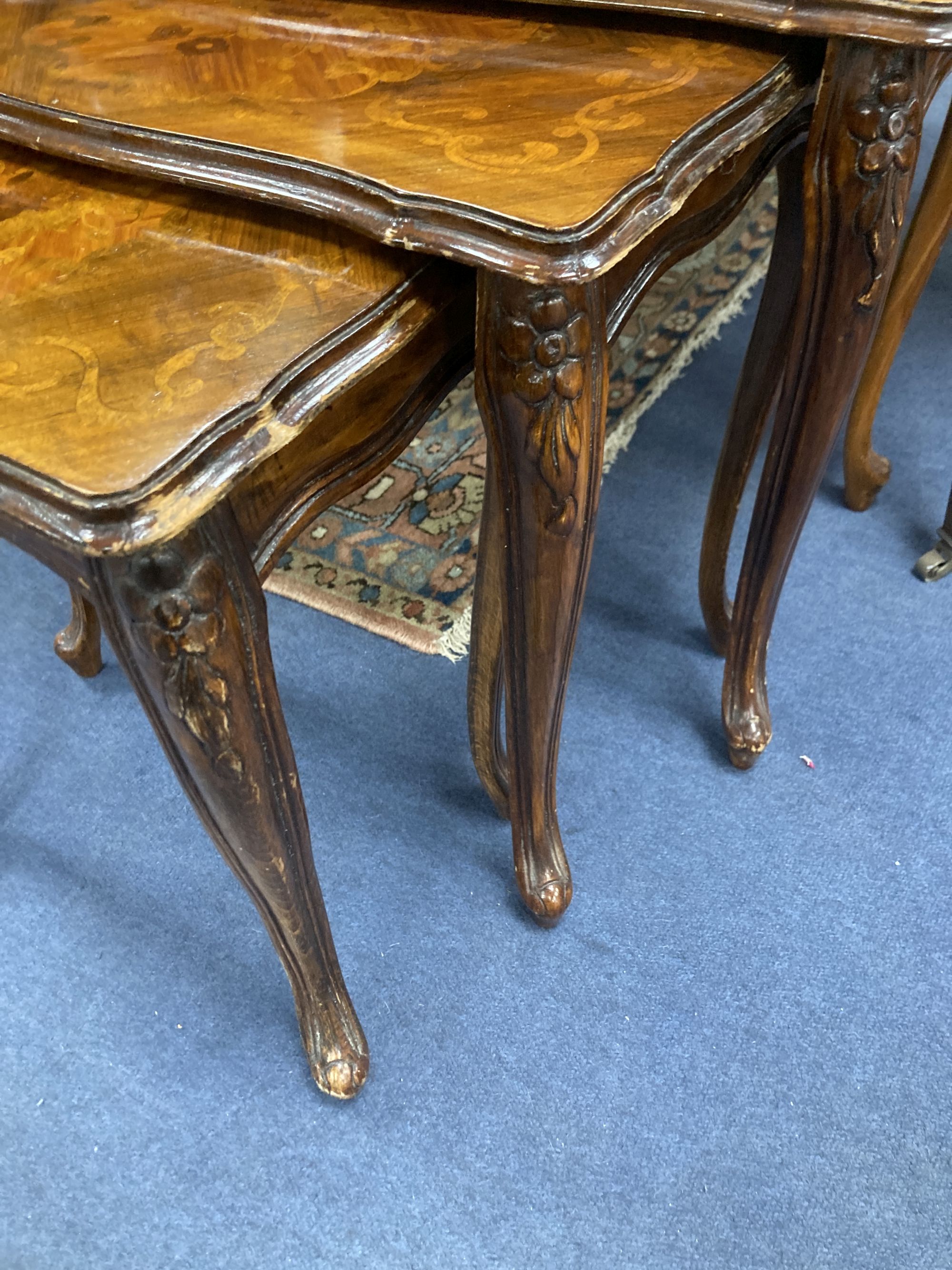 A nest of three marquetry inlaid walnut tea tables, width 59cm, depth 36cm, height 49cm